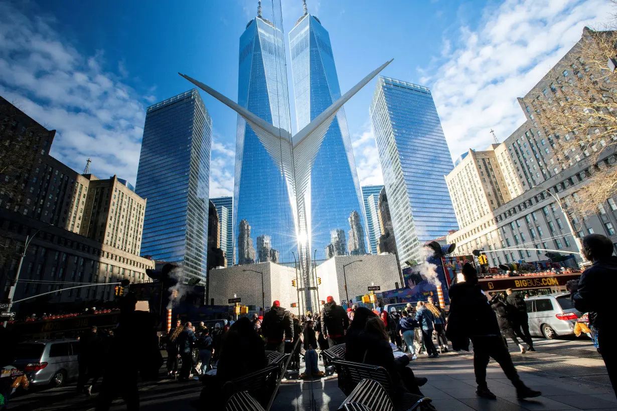 FILE PHOTO: People are seen walking near the New York Stock Exchange (NYSE) in New York, U.S.