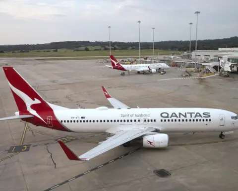 Qantas agrees to pay $79 million in compensation and a fine for selling seats on canceled flights