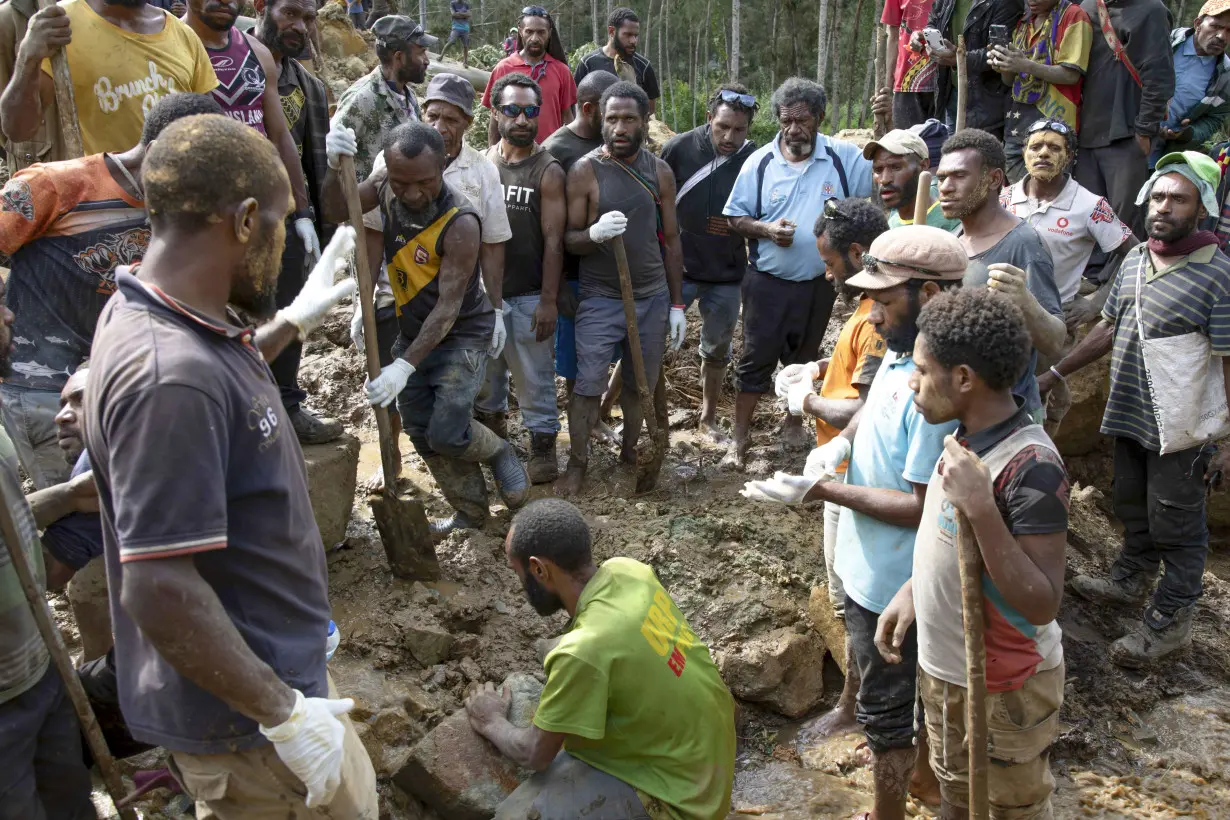 Papua New Guinea's prime minister visits the site of a landslide estimated to have killed hundreds