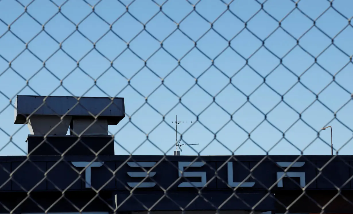 A Tesla sign is displayed over a Tesla showroom in Malmo