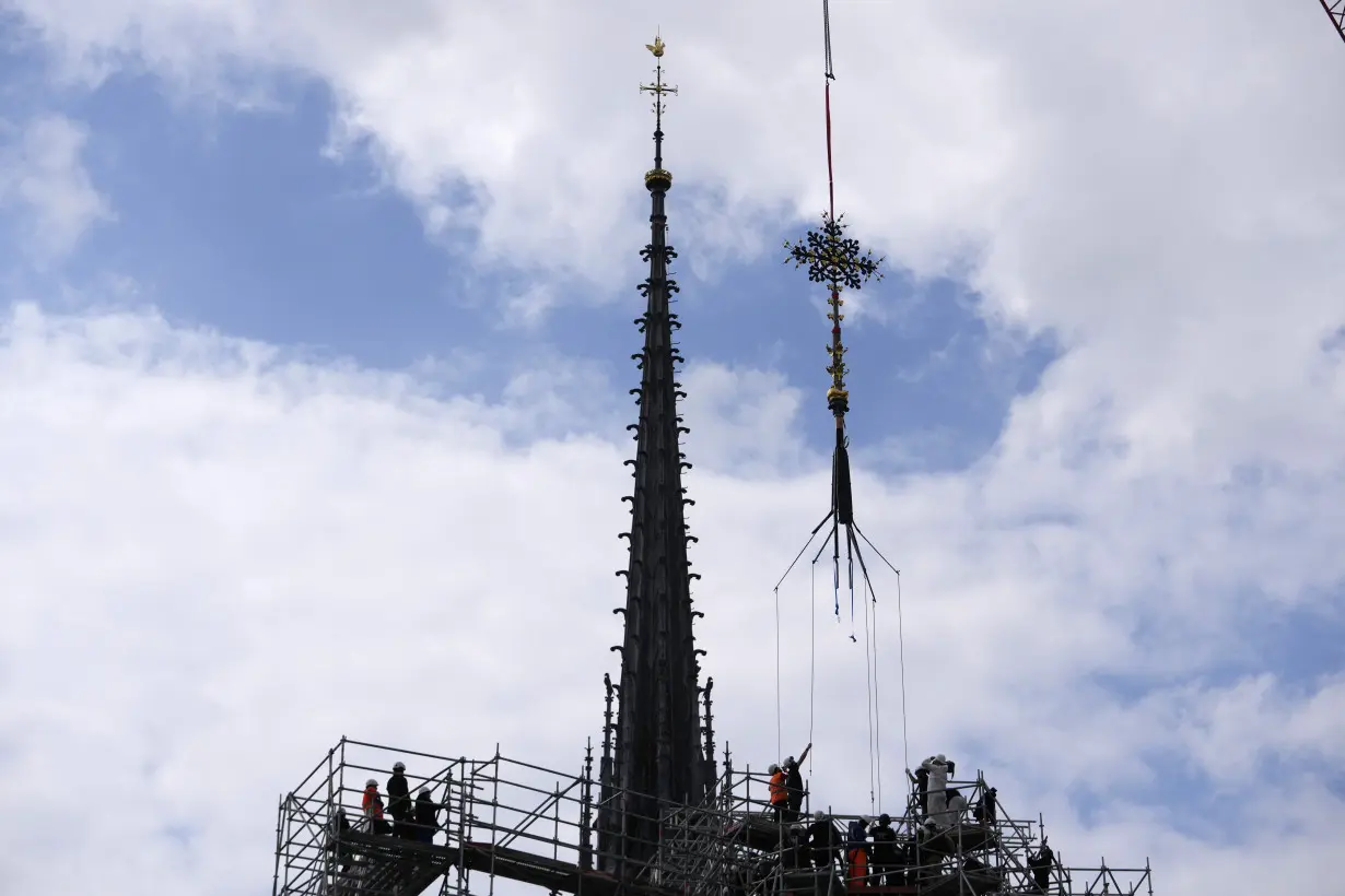 Notre Dame cathedral cross reinstalled in Paris amid restoration efforts