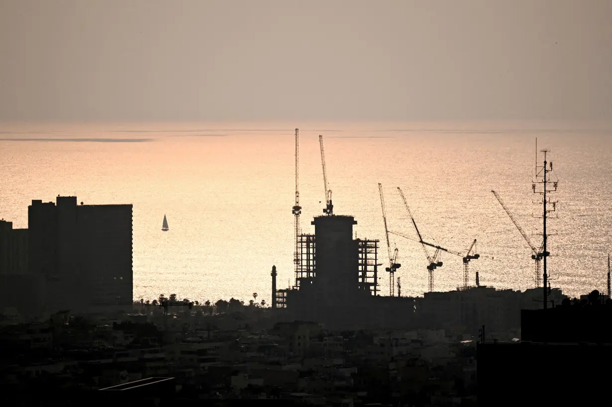 FILE PHOTO: Construction work during the sunset in Tel Aviv