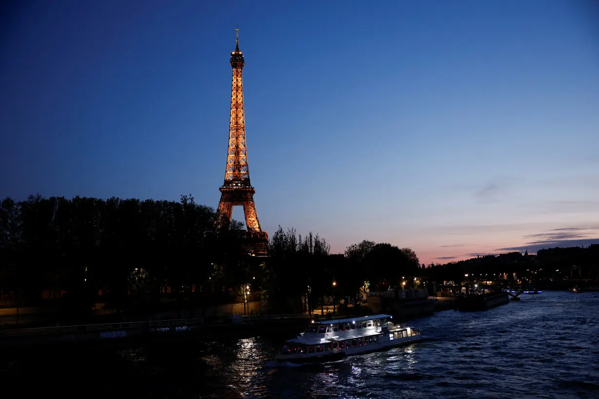 The River Seine near the Alma bridge with the Eiffel Tower in the background at night in Paris