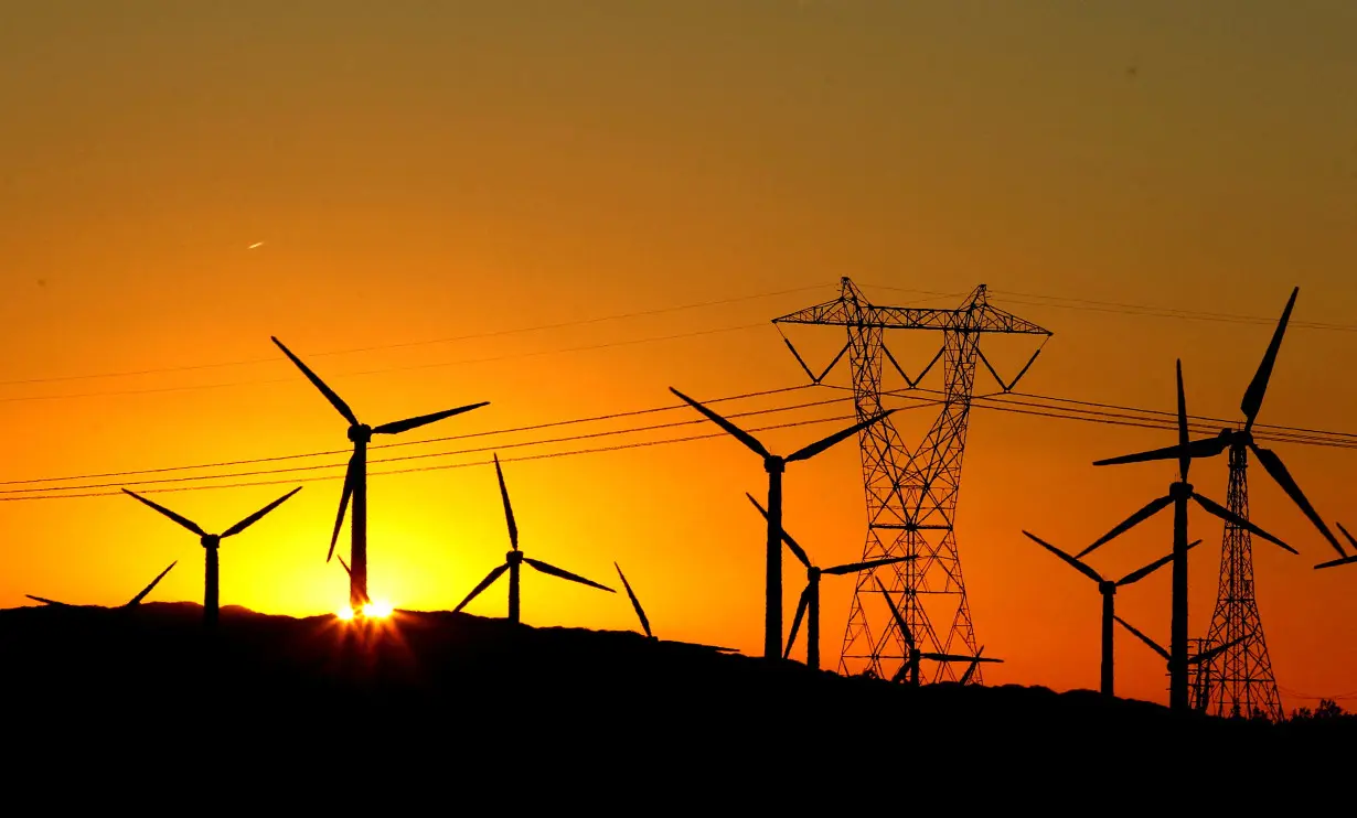 FILE PHOTO: The sun rises behind windmills at a wind farm in Palm Springs, California, February 9, 2011. REUTERS/Lucy Nicholson