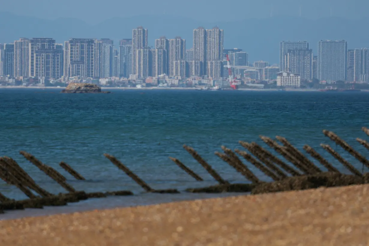 FILE PHOTO: Anti-landing barricades are pictured on the beach, with China's Xiamen city in the background, in Kinmen