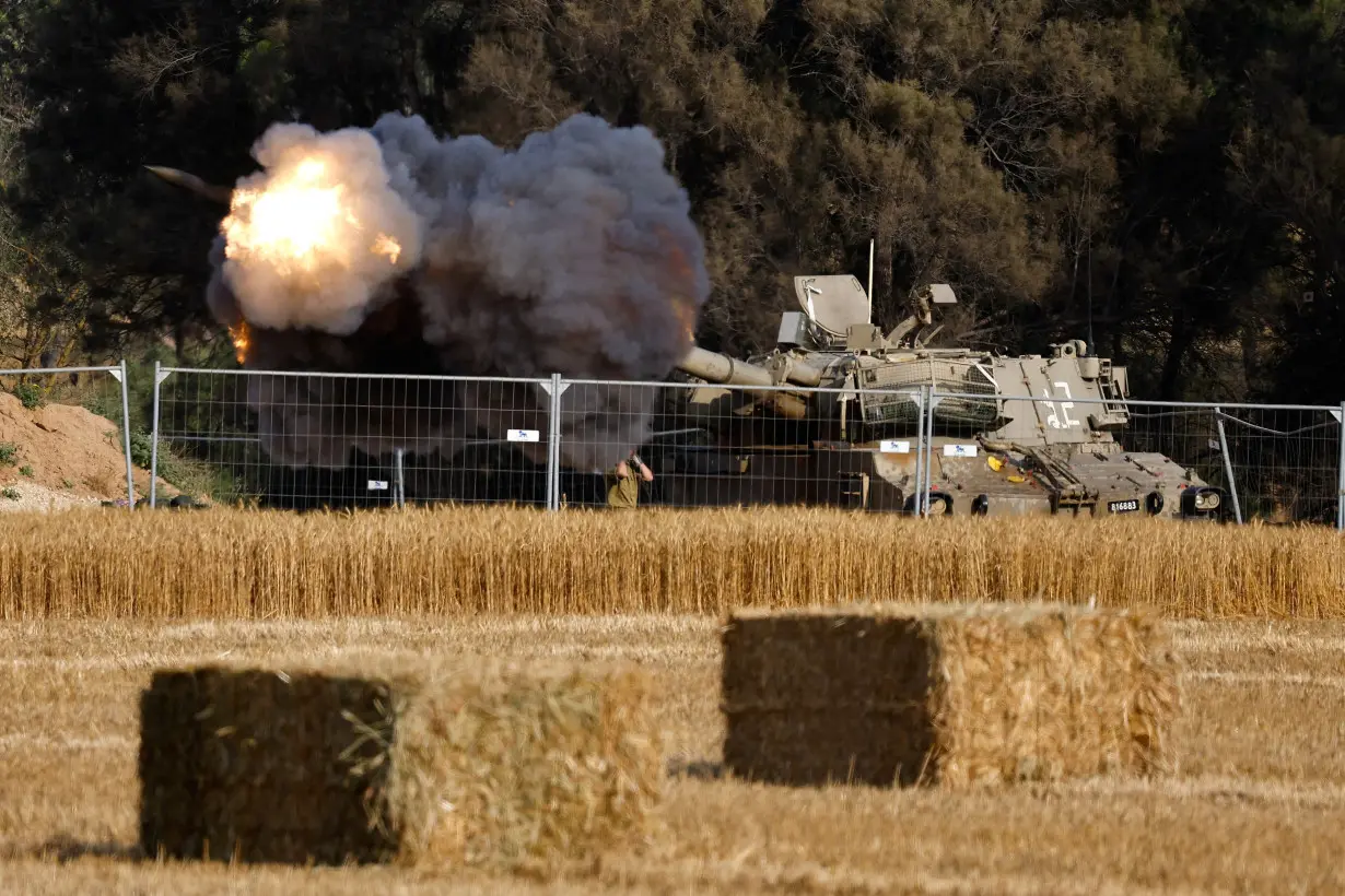 FILE PHOTO: An Israeli mobile artillery unit fires towards Gaza, near the Israel-Gaza border