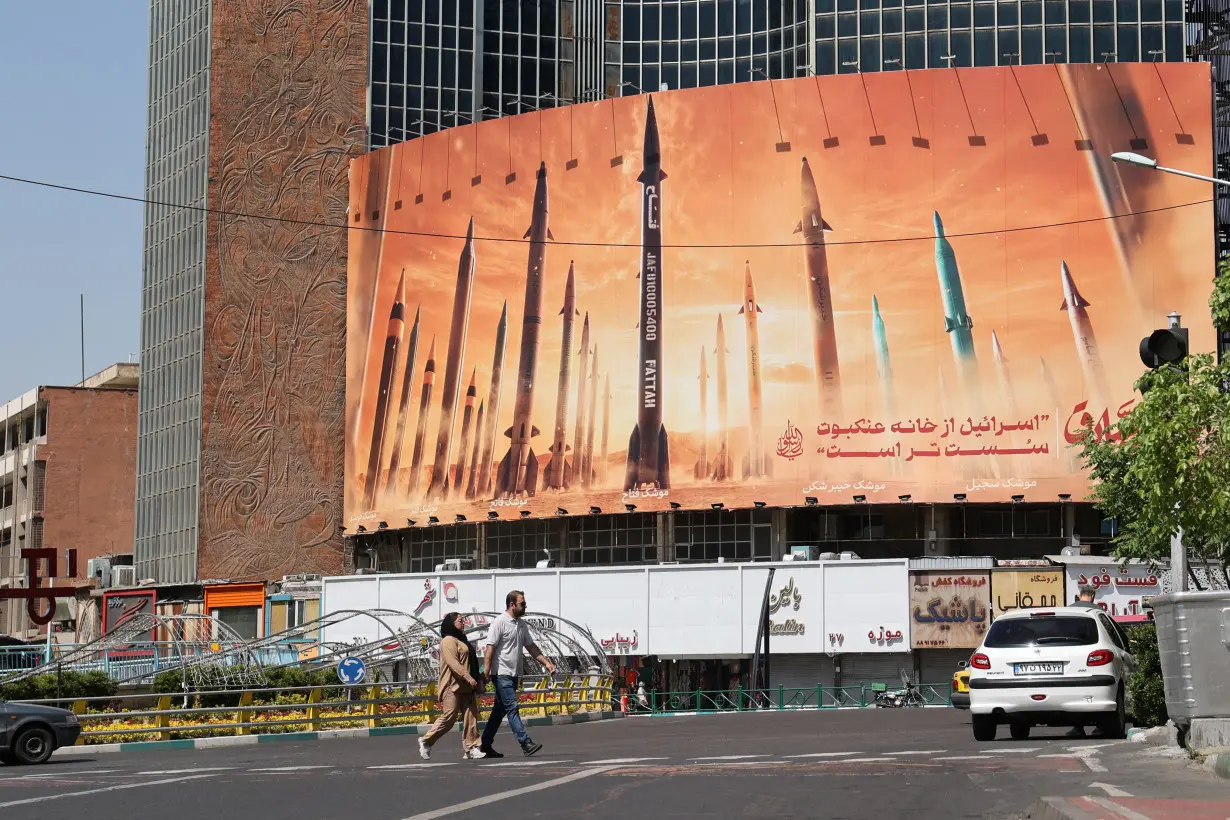 An anti-Israel billboard with a picture of Iranian missiles is seen on a street in Tehran