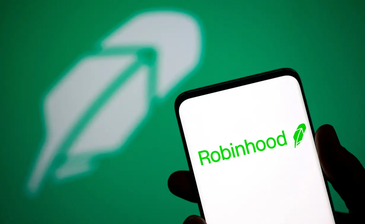 FILE PHOTO: Robinhood logo is seen on a smartphone in front of a displayed same logo in this illustration taken