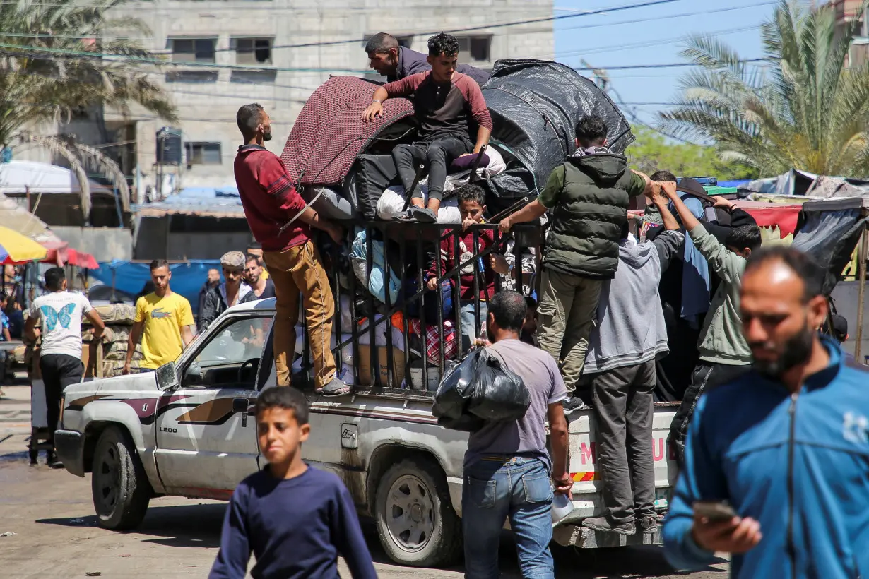 Palestinians evacuate after Israeli forces launched a ground and air operation in the eastern part of Rafah