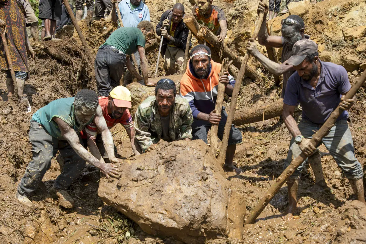 Papua New Guinea's prime minister visits the site of a landslide estimated to have killed hundreds