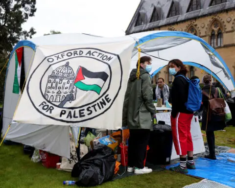 With bright tents and sombre mood, protesting UK students show solidarity with US peers