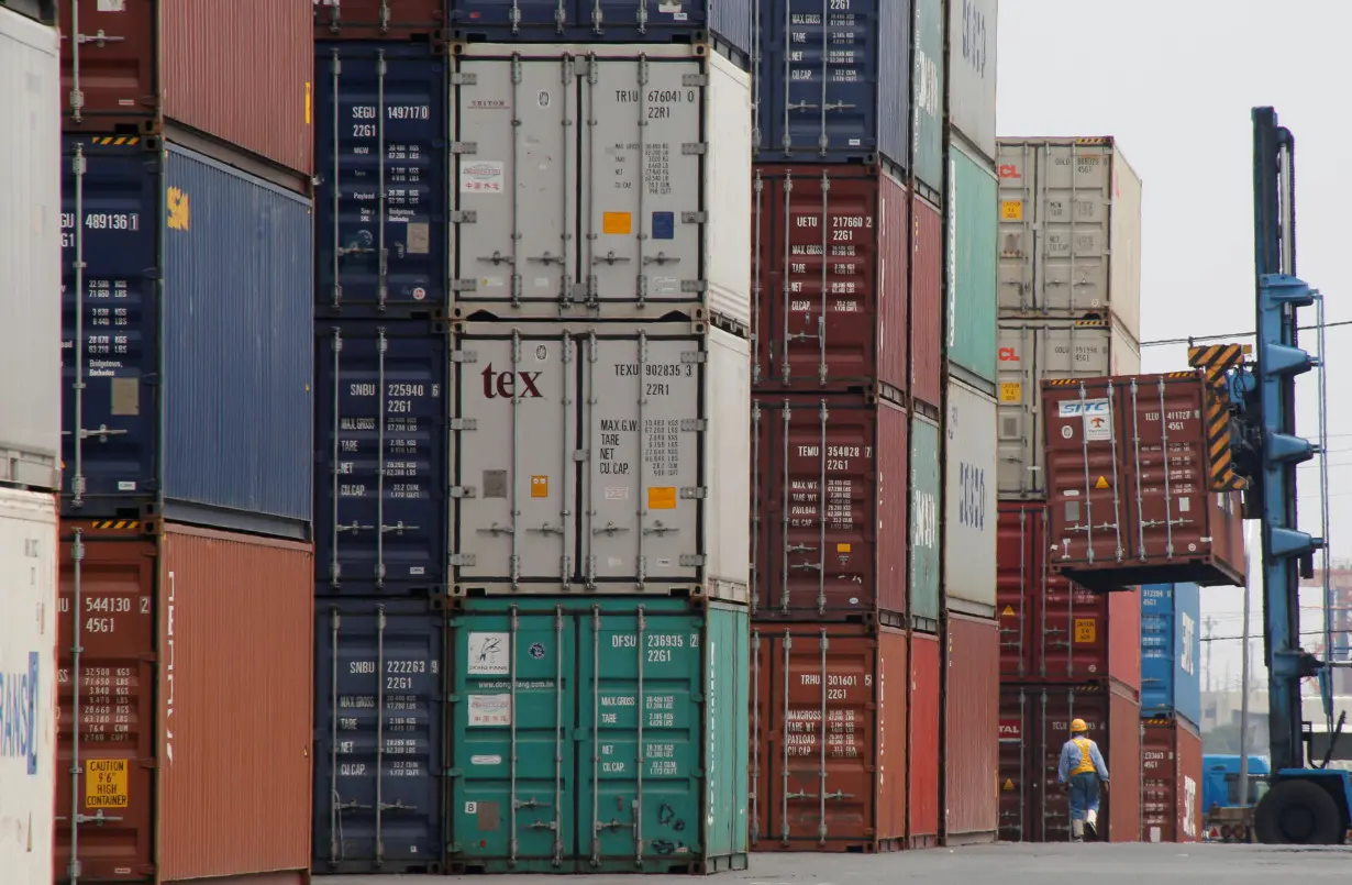 A laborer works in a container area at a port in Tokyo