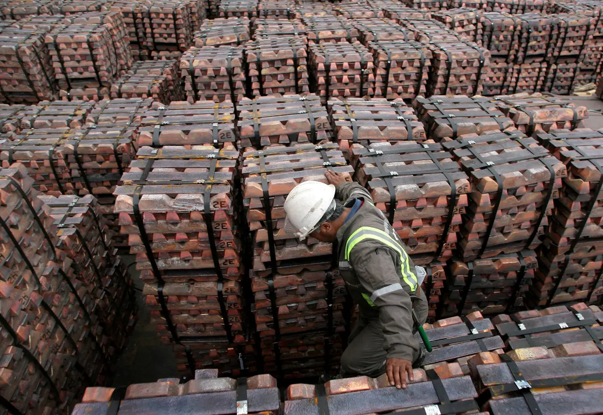 A port worker checks a shipment of copper that is to be exported to Asia in Valparaiso port, Chile