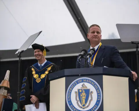 Billionaire rains cash on UMass graduates to tune of $1,000 each, but says they must give half away