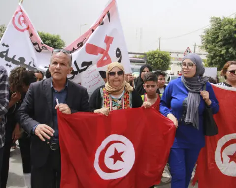 Tunisians stage anti-migrant protest as the number of stranded in transit to Europe grows