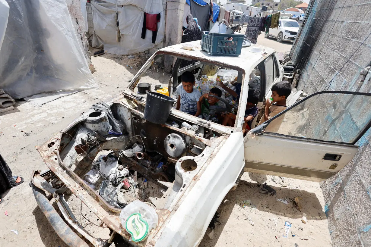 Displaced Palestinians, who fled their house due to Israel's military offensive shelter in a tent, in Rafah