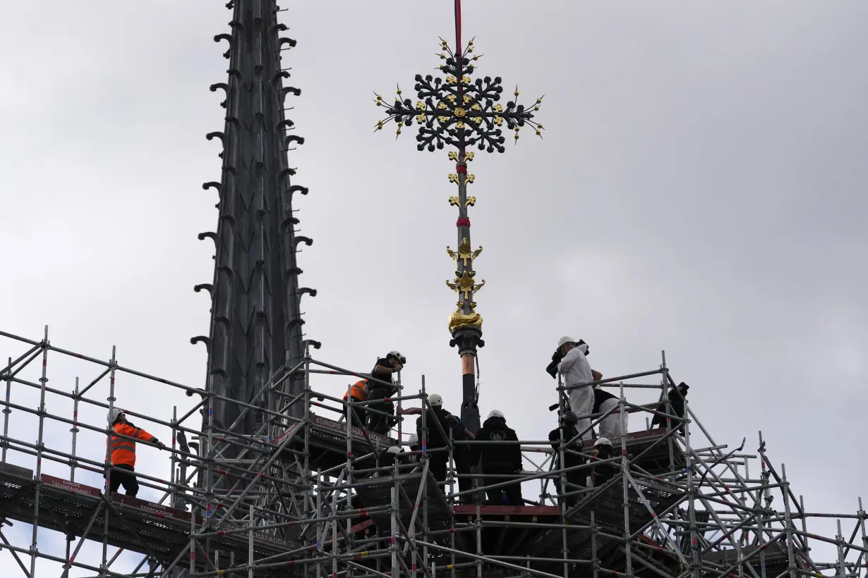 Notre Dame cathedral cross reinstalled in Paris amid restoration efforts