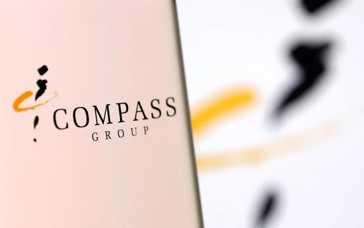 FILE PHOTO: Illustration shows smartphone with Compass Group's logo displayed