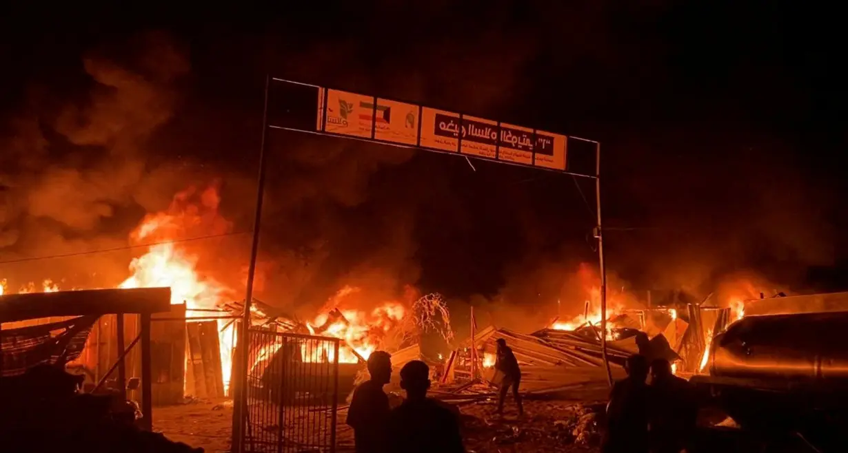 Fire rages following an Israeli strike on an area designated for displaced Palestinians, in Rafah