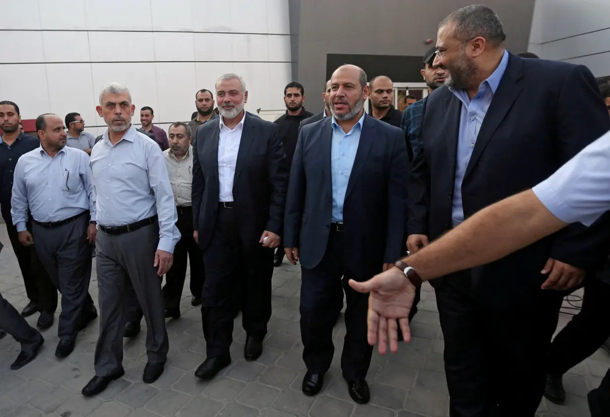 FILE PHOTO: Hamas Gaza Chief Yahya Al-Sinwar, Hamas Chief Ismail Haniyeh and senior Hamas leader Khalil al-Hayya arrive at the Rafah border crossing in the southern Gaza Strip