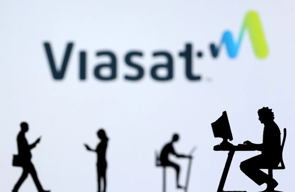 FILE PHOTO: Illustration shows small toy figures with laptops and smartphones in front of displayed Viasat Internet logo