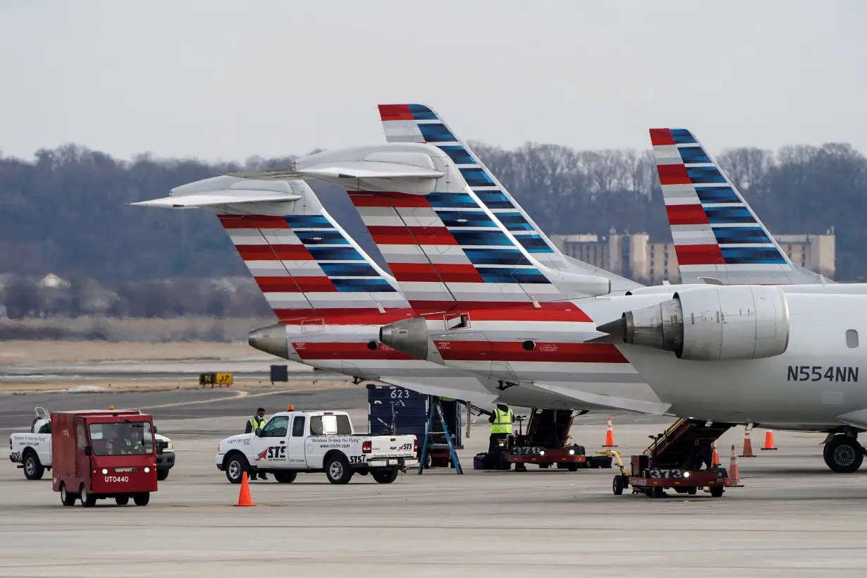 FILE PHOTO: Grounds crews work around American Airlines aircraft at Reagan National Airport in Arlington, Virginia