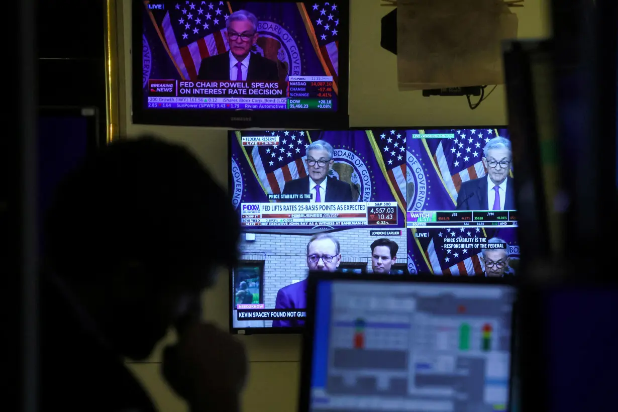 FILE PHOTO: Traders react to Fed rate announcement on the floor of the NYSE in New York