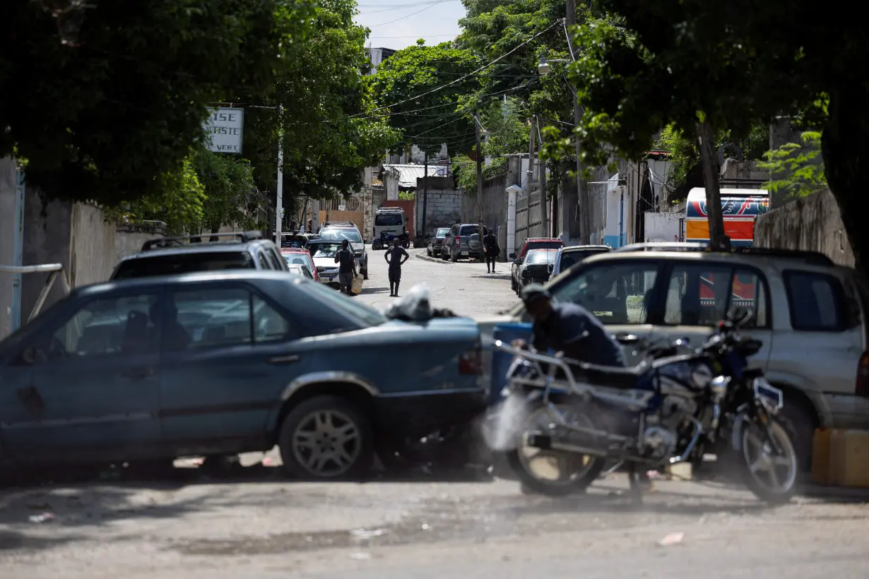 FILE PHOTO: A view of a makeshift barricade built by residents out of abandoned vehicles to block a road and prevent gangs from entering their community, in Port-au-Prince