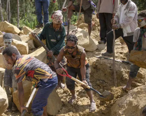 Papua New Guinea's prime minister visits the site of a landslide estimated to have killed hundreds