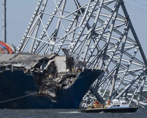 Collapsed Baltimore bridge span comes down with a boom after crews set off chain of explosives