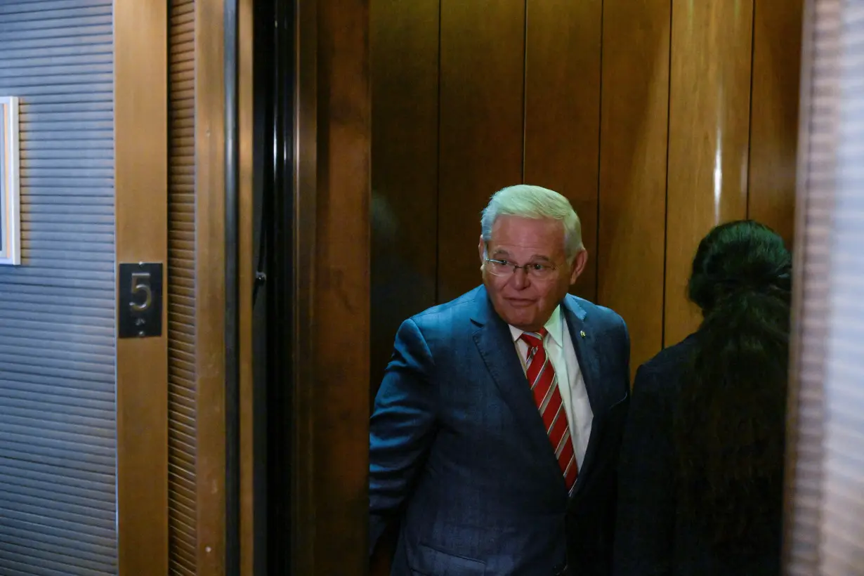 U.S. Senator Bob Menendez (D-NJ) speaks to reporters while on his way to a vote following a Senate Democratic caucus meeting on Capitol Hill in Washington