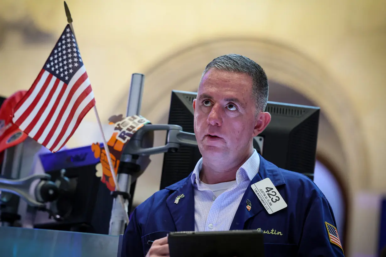 Traders work on the floor of the NYSE in New York