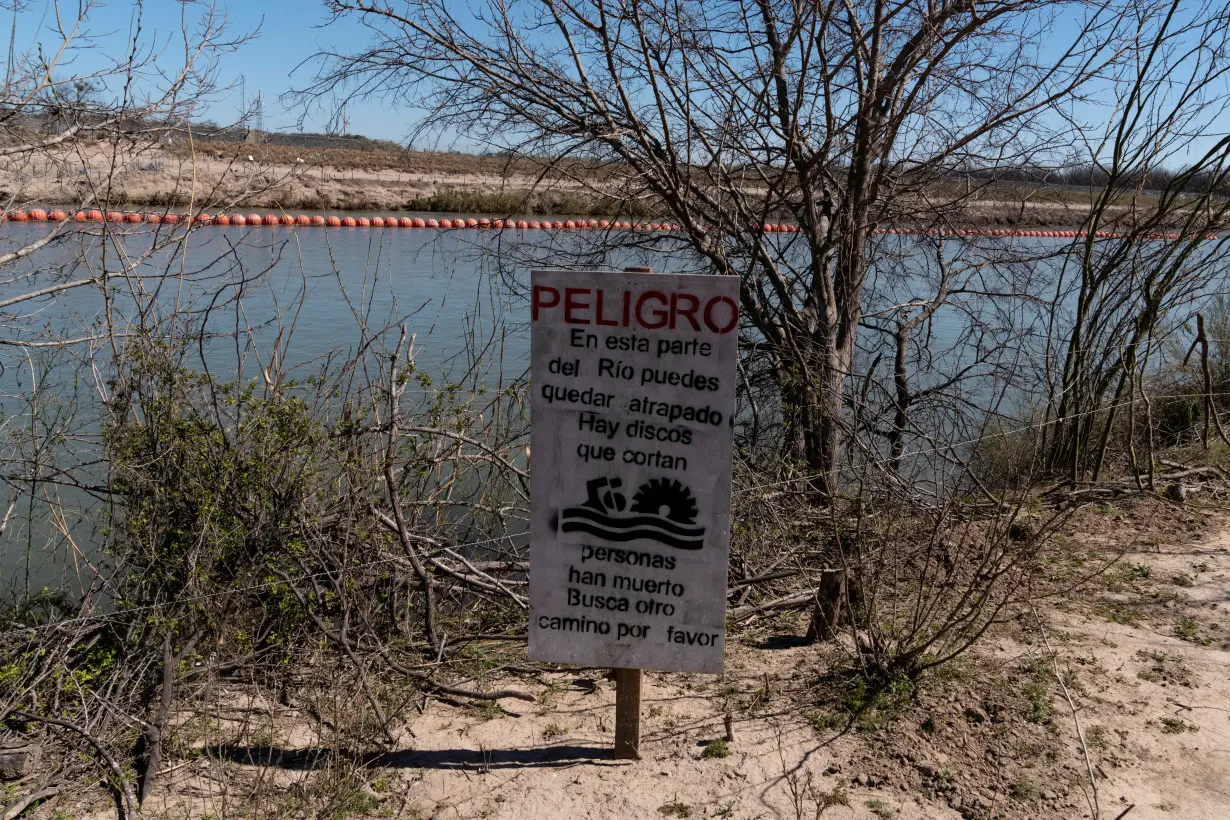 A sign warns migrants of the extreme danger of attempting to cross into the United States, in Piedras Negras