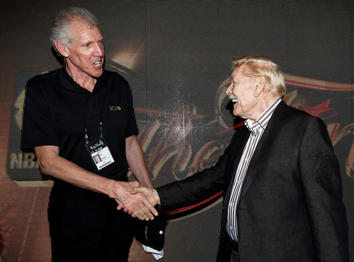 FILE PHOTO: Fomer NBA star Bill Walton talks with Lakers team owner Jerry Buss after Game 7 of the 2010 NBA Finals basketball series in Los Angeles