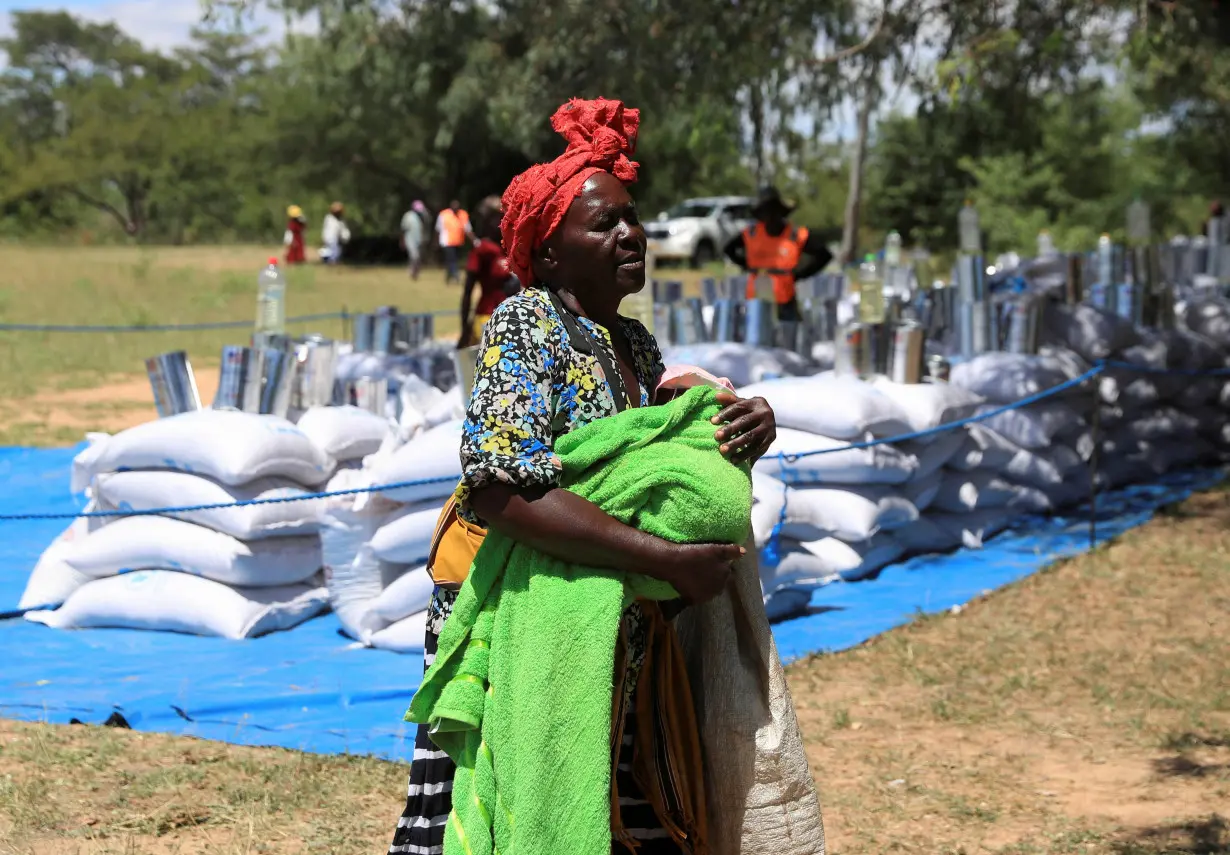 FILE PHOTO: Villagers collect monthly allocations of food aid provided by WFP in Mumijo