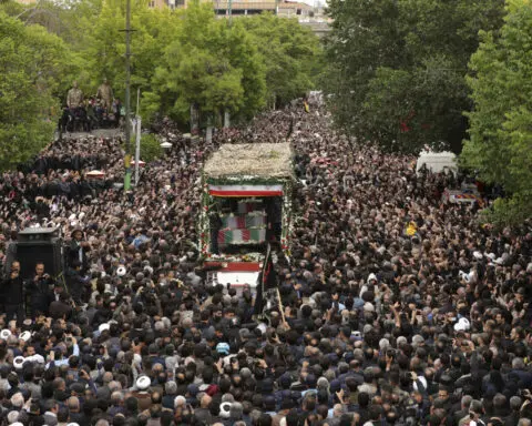 Mourners begin days of funerals for Iran's president and others killed in helicopter crash