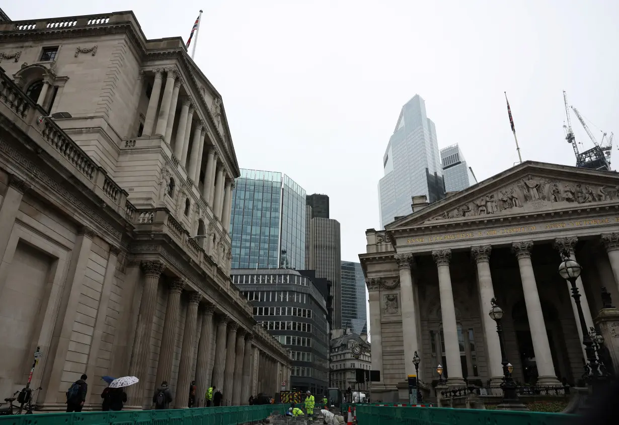 Road construction workers carry out work outside the Bank of England in the City of London financial district