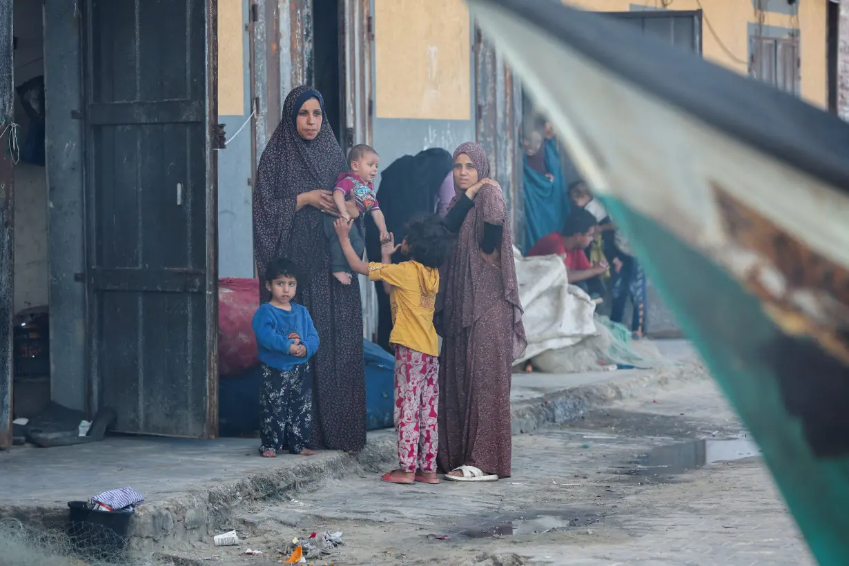 Palestinians inspect boats damaged in Israeli fire, in Rafah in the southern Gaza Strip