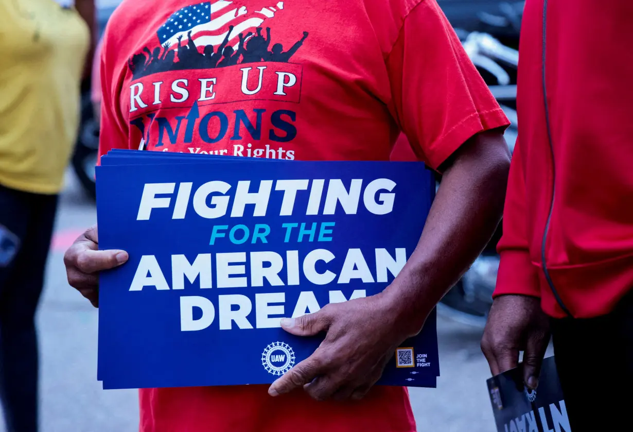 FILE PHOTO: A United Auto Workers union member holds a sign outside Stellantis Sterling Heights Assembly