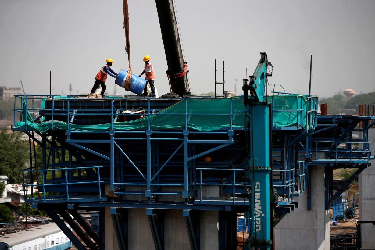 FILE PHOTO: Labourers work at a construction site of the Ahmedabad-Mumbai High Speed Rail corridor in Ahmedabad