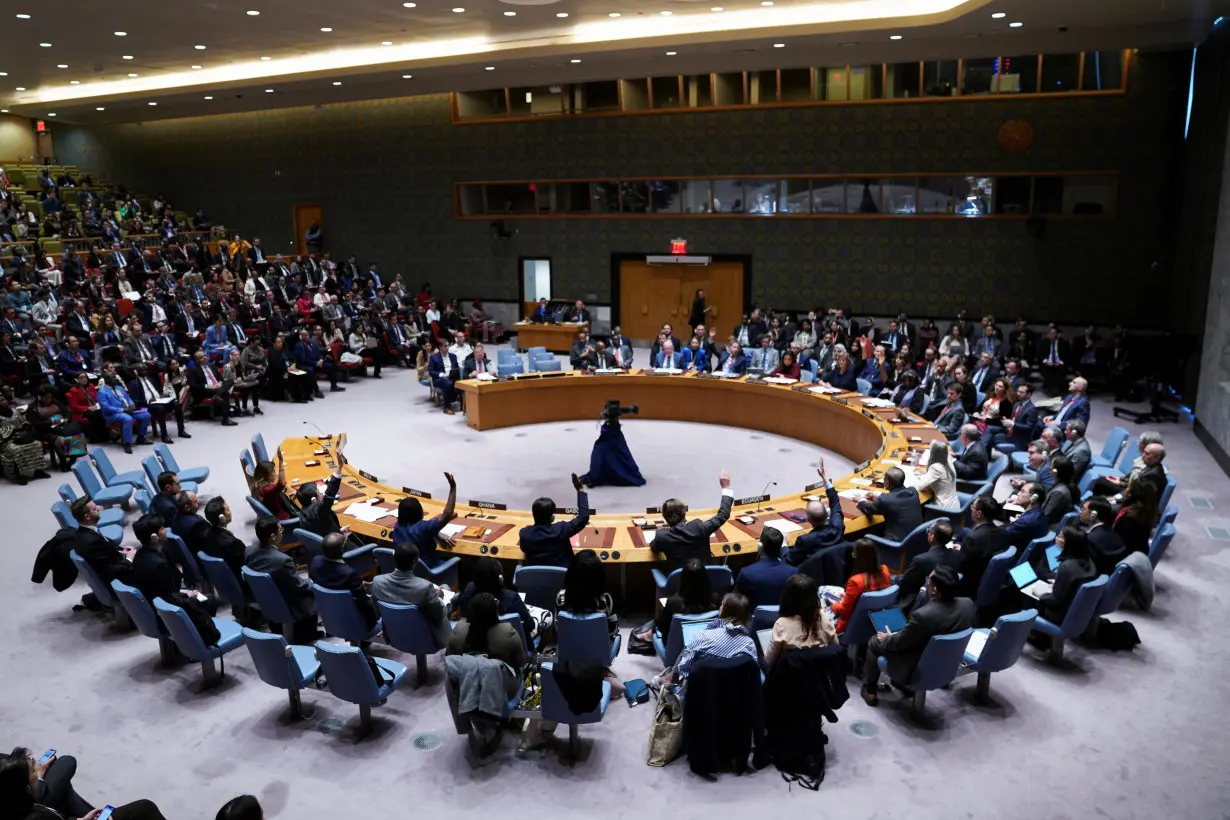 Members of the U.N. Security Council vote during a meeting on the conflict between Israel and Hamas