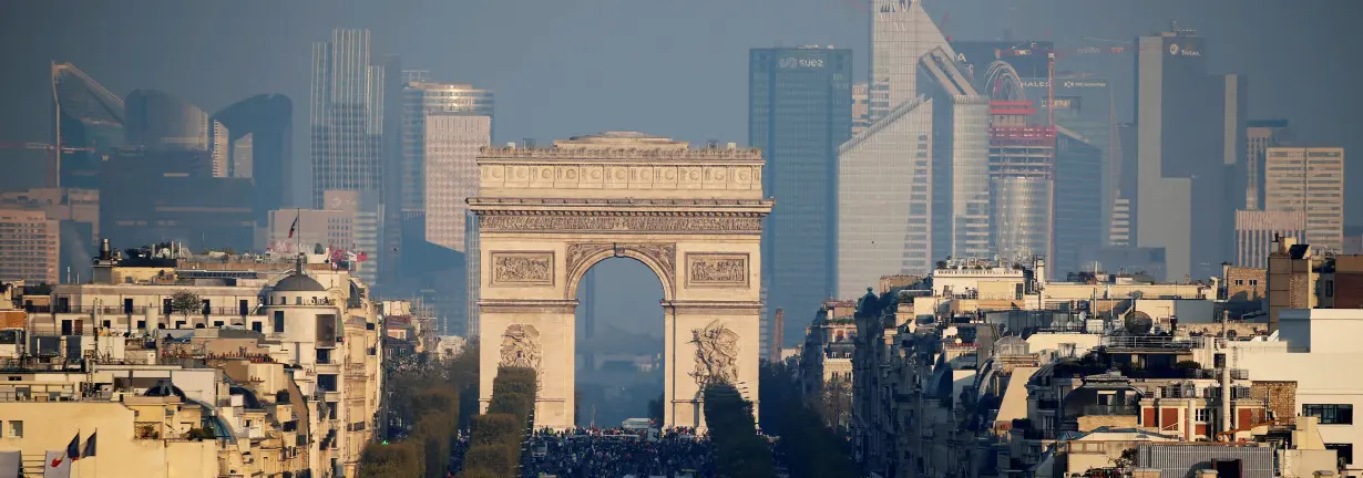 FILE PHOTO: General view of the skyline of La Defense business district behind the Arc de Triomphe and the Champs Elysees Avenue in Paris, France