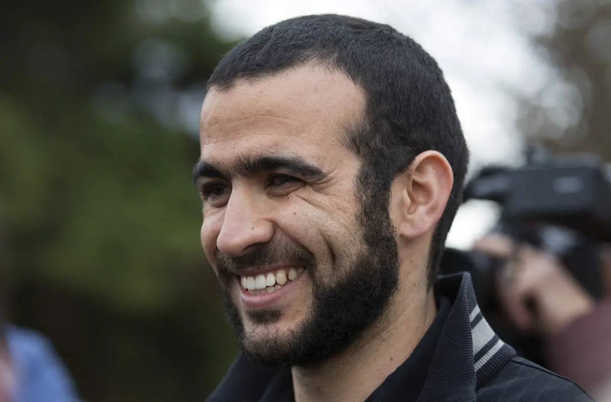 FILE PHOTO: Omar Khadr smiles as he answers questions during a news conference after being released on bail in Edmonton, Alberta