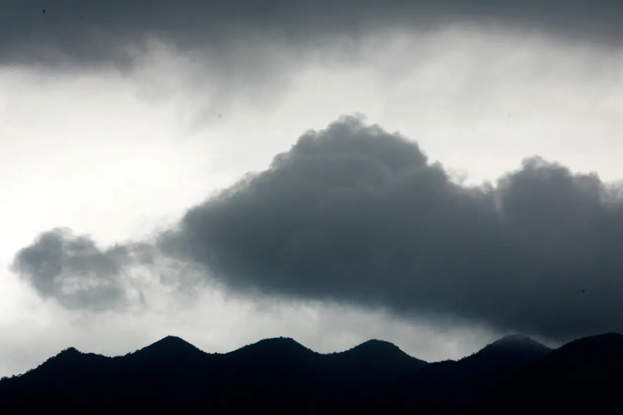 FILE PHOTO: Dark clouds gather over mountains in Zhaoqing, southern China's Guangdong province.