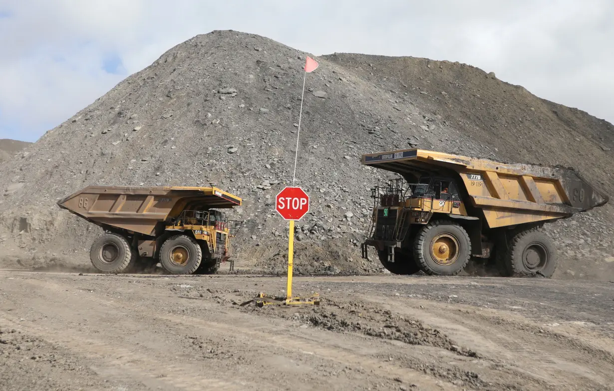 FILE PHOTO: Dump trucks haul coal and sediment at the Black Butte coal mine outside Rock Springs, Wyoming, U.S.