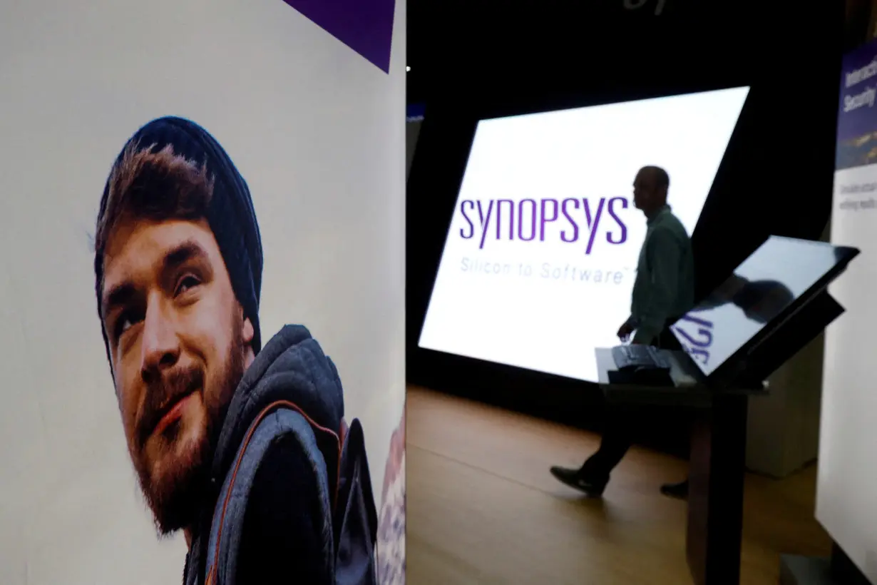 FILE PHOTO: A man walks through the Synopsys booth during the Black Hat information security conference in Las Vegas