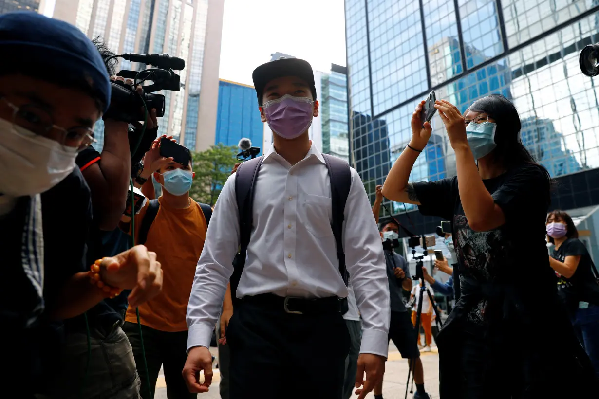 Tsang Chi-kin, who was shot in the chest during a protest last year, arrives at the District Court to face charges of rioting, in Hong Kong