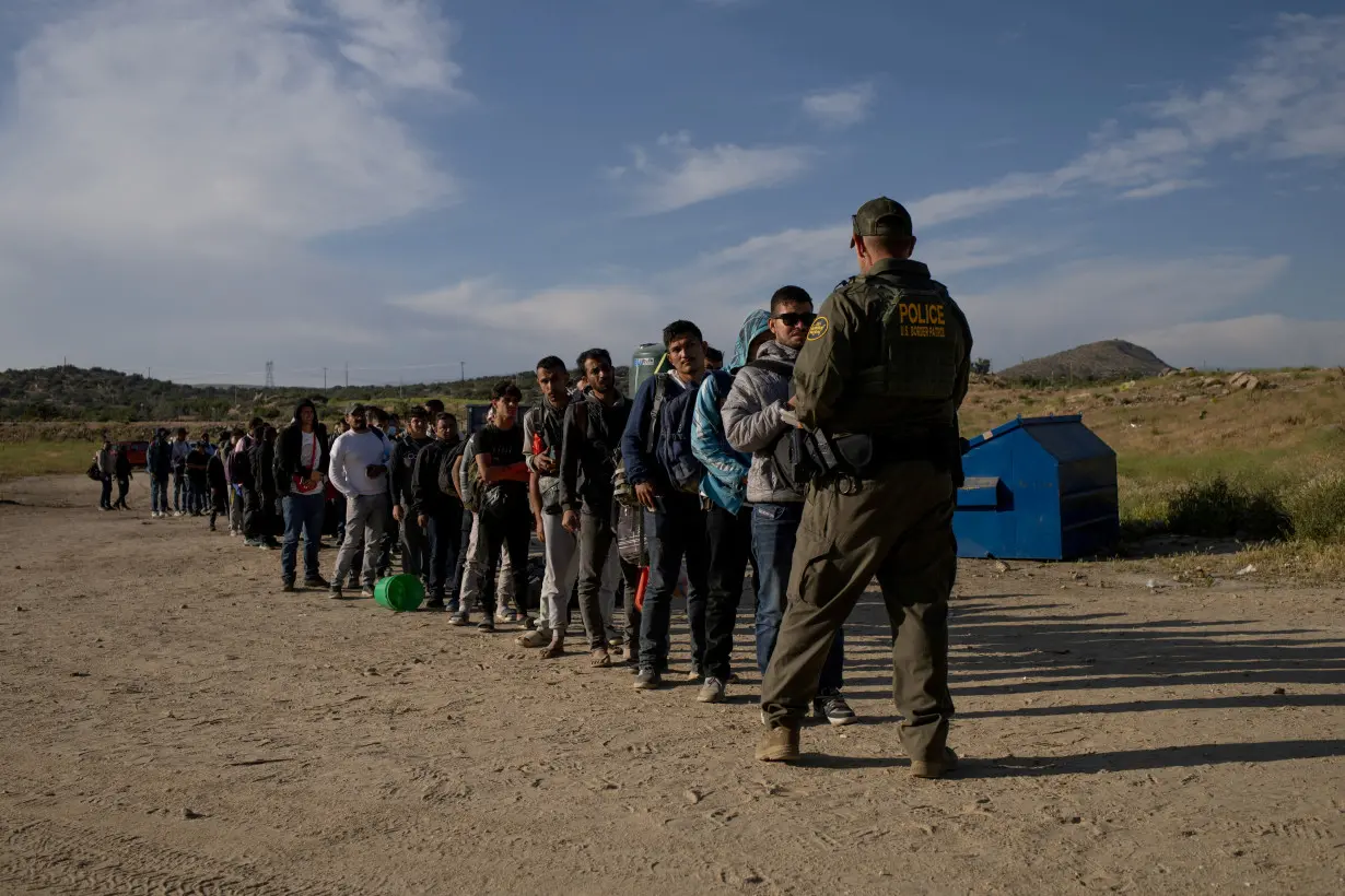 FILE PHOTO: Migrants surrender to authoritites after crossing into Jacumba Hot Springs from Mexico