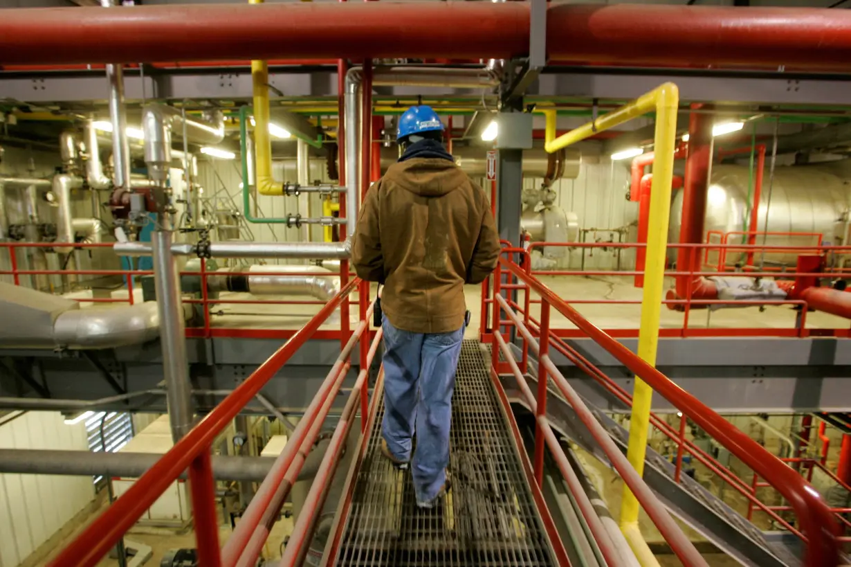 FILE PHOTO: Travis Harrison walks among the pipes that process corn into ethanol at the Lincolnway Energy plant in Nevada, Iowa
