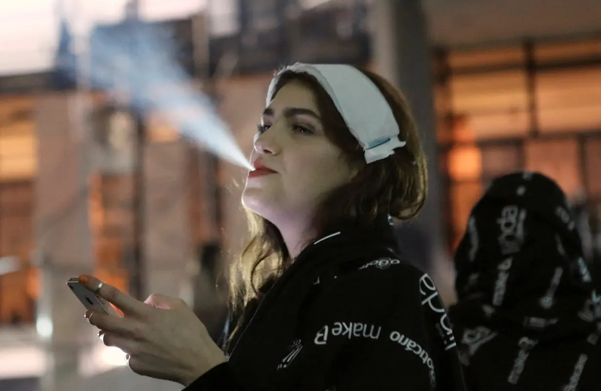 FILE PHOTO: A model smokes a cigarette during Sao Paulo Fashion Week